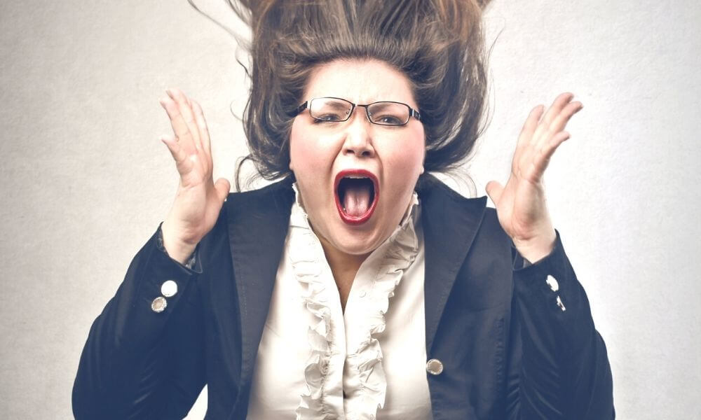 woman screaming in frustration because she hired a crappy freelance website designer