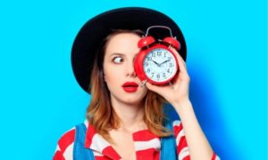 woman holding a clock to illustrate the urgent reason you need product reviews for your small business