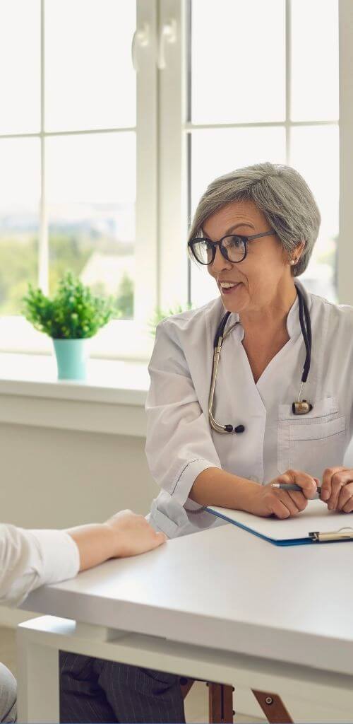 mature female doctor talking with patient loudbird digital marketing for doctors